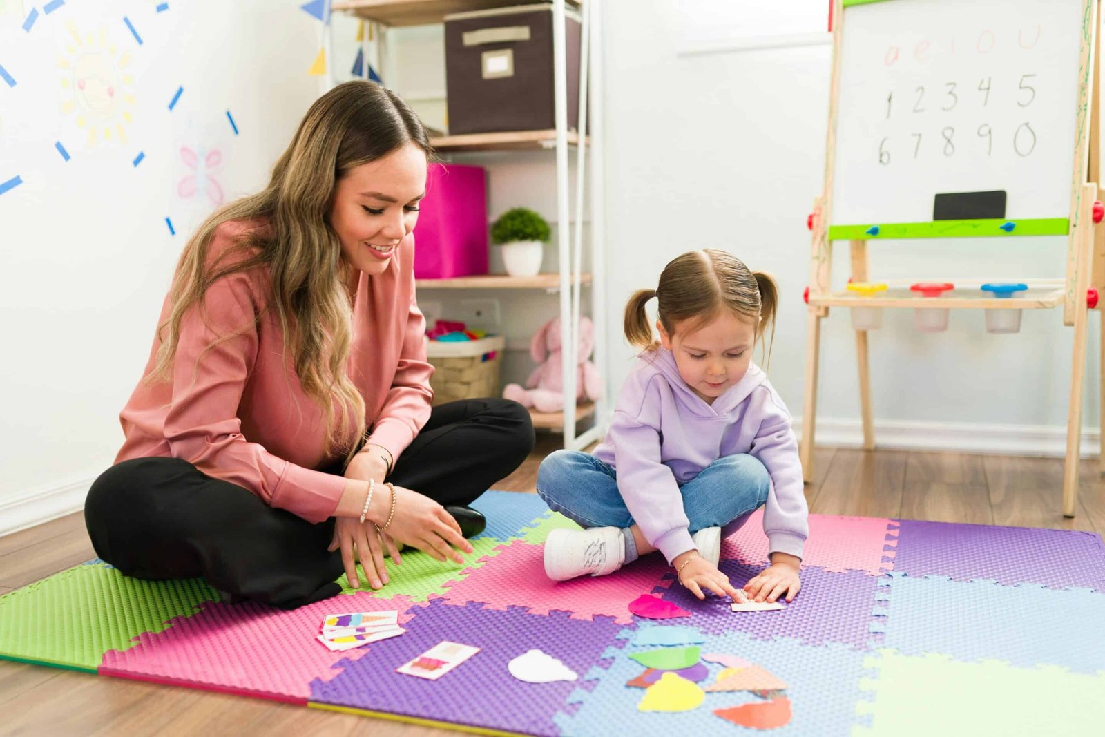 getty-images-R8XGehpWb9E-unsplash young girl working with occupational therapist